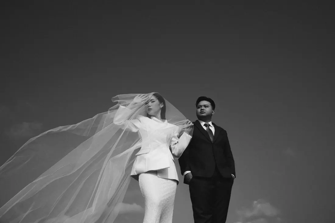Stephanie’s veil blowing in the wind, Irfan standing beside her