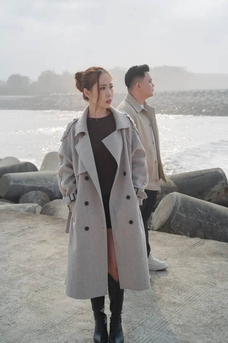 Stephanie in a long coat by the seaside