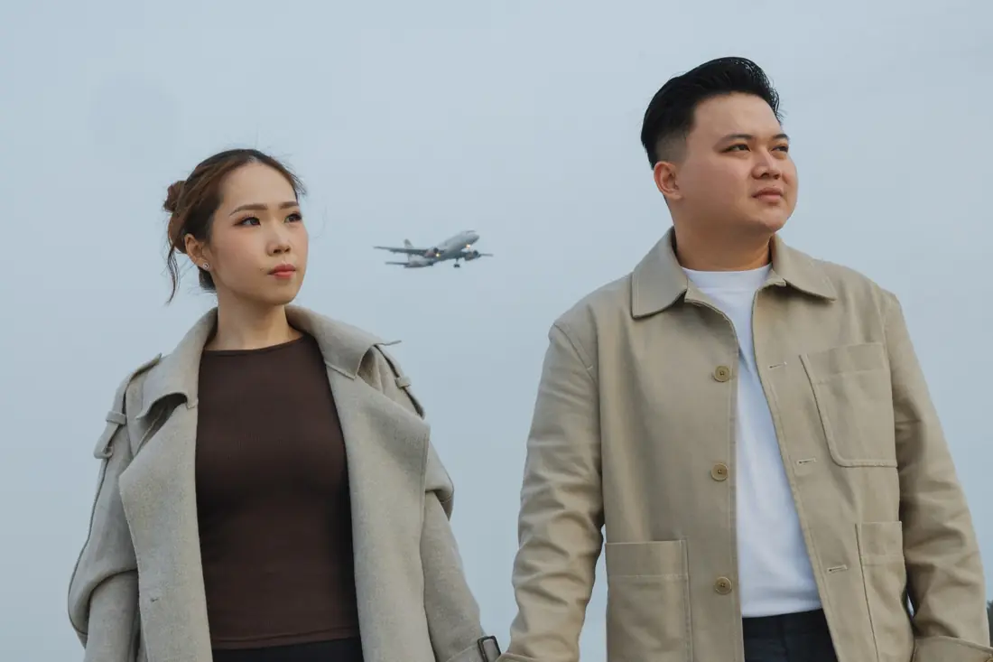 Irfan and Stephanie gazing away, a plane in the sky behind them