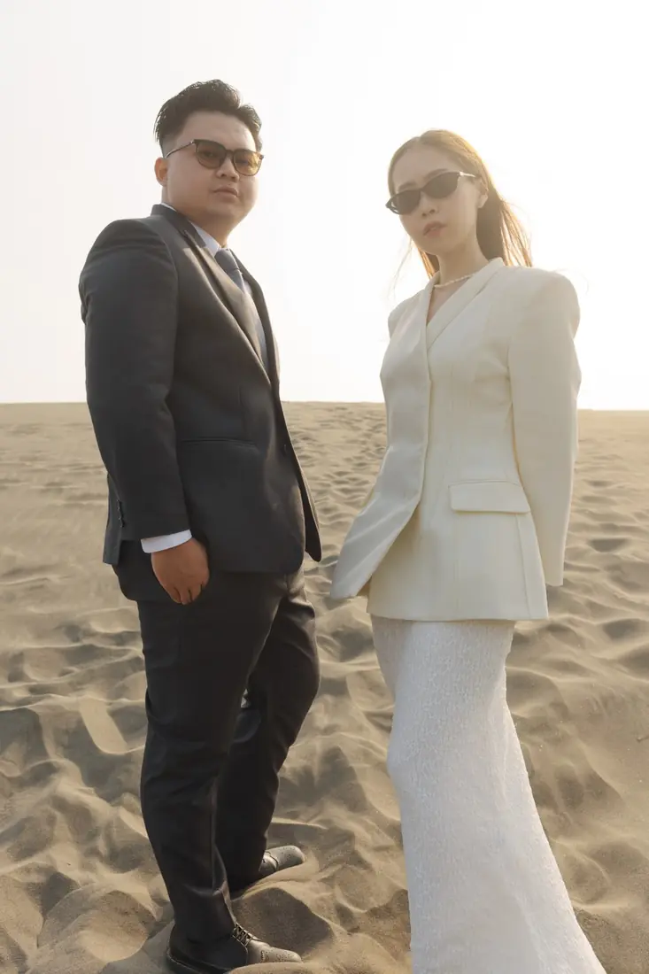 Irfan and Stephanie in sunglasses on the dunes
