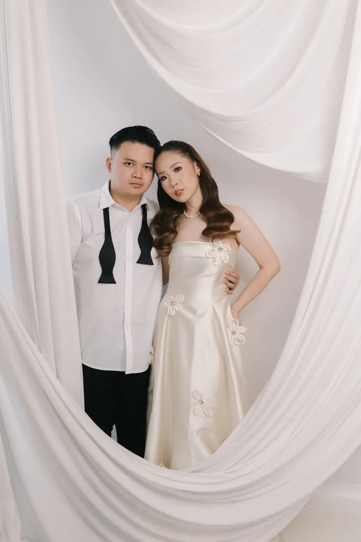 Irfan and Stephanie framed by white drapes